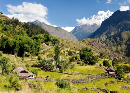 Beautiful village in western Nepal with mount Dhaulagiriの写真素材