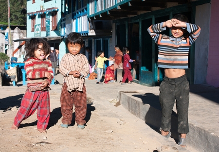 SHIVALAYA NEPAL 25th OCTOBER 2010  children in Shivalaya village near Jiri Bazar on the trekking route to Everest base camp. Typical Nepalese children standing on street.のeditorial素材