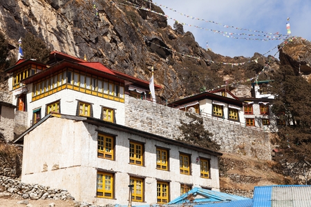 Thame gompa with prayer flags and buddhist symbols - monastery in Khumbu valley on three passes trek, Mount Everest area, Sagarmatha national park, Nepalese Himalayasのeditorial素材