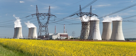 Nuclear power plant Dukovany with golden flowering field of rapeseed - Czech Republic - two possibility for production energyの写真素材