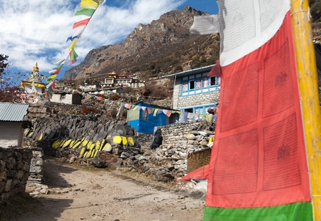 Thamo gompa with prayer flags and buddhist symbols - monastery in Khumbu valley on three passes trek, Mount Everest area, Sagarmatha national park, Nepalの写真素材