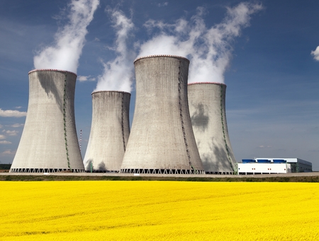Nuclear power plant Dukovany with golden flowering field of rapeseed - Czech Republic - two possibility for production of energyの写真素材