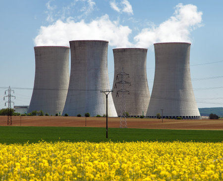 Nuclear power plant Dukovany with golden flowering field of rapeseed - Czech Republic - two...