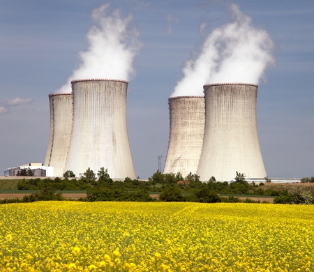 Nuclear power plant Dukovany with golden flowering field of rapeseed - Czech Republic - two possibility for production of energyの写真素材
