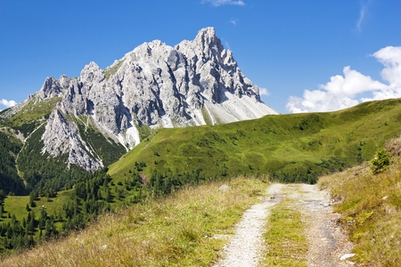 Crode Dei Longerin with rural road - Alpi Carniche or Karnische Alpen - Dolomiti - Italyの写真素材