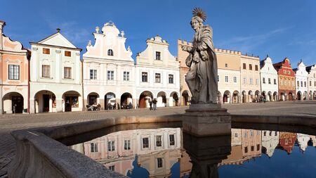 TELC, CZECH REPUBLIC, 28TH AUGUST 2015 - Evening view of Telc or Teltsch town square, building mirroring in public fountain with statue of st. Margaret, Czech republic. World heritage site by unescoのeditorial素材