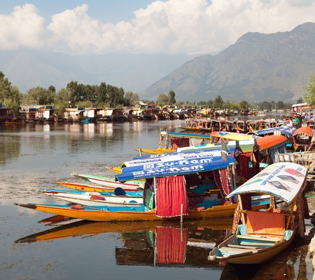 KASHMIR, INDIA - AUG 3 Shikara boats on Dal Lake with houseboats in Srinagar - Shikara is a small boat used for transportation in the Dal lake - 3rd of August 2013, Srinagar, Jammu and Kashmir, Indiaのeditorial素材