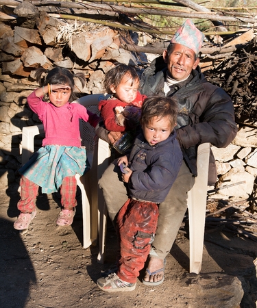 SIM VILLAGE, WESTERN NEPAL, 15TH OF NOVEMBER 2013 - man and three children in Sim village, western nepalのeditorial素材