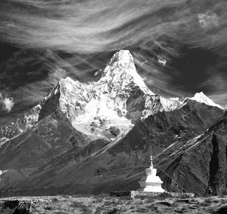 Mount Ama Dablam with stupa near Pangboche village and beautiful cloudy sky, black and white view, way to mount Everest base camp, Khumbu valley,の写真素材