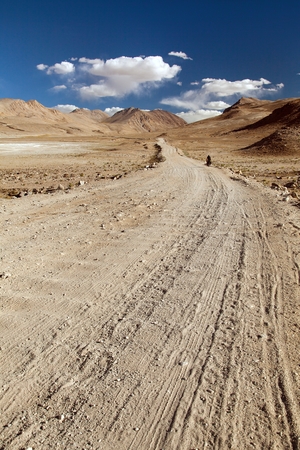 Pamir highway or Pamirskij trakt with biker, there is one of the best cycling road on the world. Unpaved road in Tajikistan, roof of the worldの写真素材