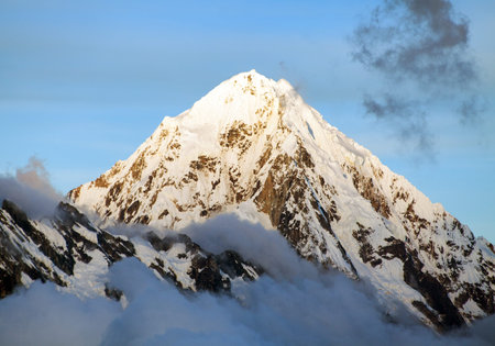Evening view of Mount Salkantay in the middle of clouds, view from Choquequirao trekking trail,...
