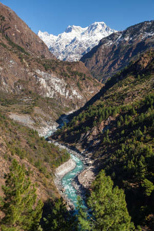 Himalaya, panoramic view of Indian Himalayas, great Himalayan range and river valley with wood, Uttarakhand Indiaの写真素材