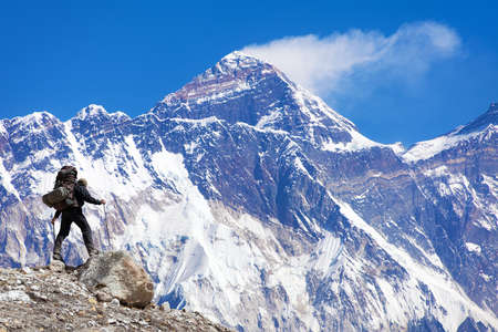 Mount Everest seen from Kongde village with tourist on the way to Everest base camp blue toned, Sagarmatha national park, Khumbu valley, Nepal Himalayas mountainsの写真素材