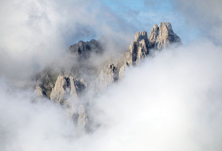 Dolomites mountains in the middle of Clouds, Carnian Alps mountains, Italy