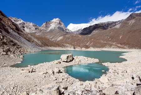 view of Tonak Tsho lake, Gokyo valley, Way to Cho Oyu and Everest Base Camp, Three passes trekking trail, Nepal Himalayas mountainsの写真素材