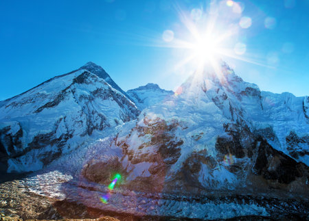 Morning sun above Mount Everest, lhotse and Nuptse from Pumo Ri base camp - Way to Everest base camp - Sagarmatha national park - Nepal Himalayas mountainsの写真素材