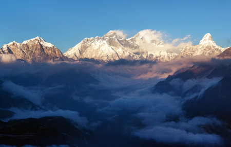 Evening sunset red colored view of mount Everest, Lhotse and Ama Dablam with beautiful clouds from Kongde village, Khumbu valley, Solukhumbu, Nepal Himalayas mountainsの写真素材