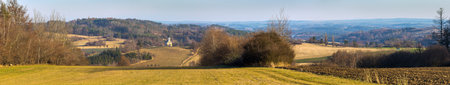 autumn landscape panorama of the Czech-Moravian highlands with fields, forests, meadow and little church near Trebic town, Czech Republicの写真素材
