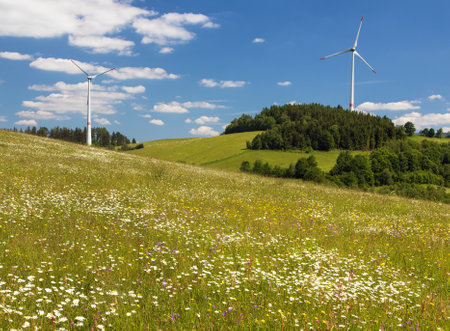 wind power plants and springtime meadow in the foothills of the Jeseniky Mountains, Czech Republicの写真素材