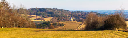 autumn landscape panorama of the Czech-Moravian highlands with fields, woods, meadow and little church near Trebic town, Czech Republicの写真素材