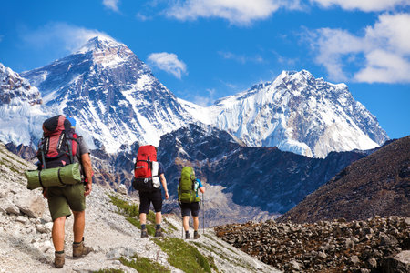Montage of Montage of three hikers and mounts Everest and Lhotse as seen from Gokyo valley, Nepal Himalayas mountains, Nepal Himalayas mountainsの写真素材