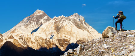 Evening sunset view of Mount Everest and Lhotse from Renjo pass and hiker. Three passes and Mt Everest base camp trek, Khumbu valley, Solukhumbu, Sagarmatha national park, Nepal Himalayas mountainsの写真素材