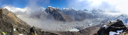 Panoramic view of Ngozumba glacier and great himalayan range from Gokyo Ri peak, Mount Everest Mt Lhotse Cho Oyu and Makalu peak, Gokyo lake, prayer flags, Nepal Himalayas mountainsの写真素材