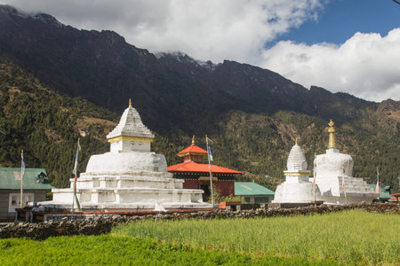 Stupa with prayer flags prayer walls and wheels on the way from Lukla to Namche bazar in...