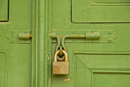 Door locked with a padlockの写真素材