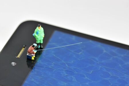 People are fishing on the phone screen.の写真素材