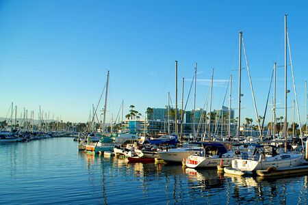 Luxury small boats and yachts at sunset docked in Marina Del Reyの写真素材