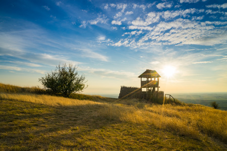 View tower in the meadow in the sunsetの写真素材