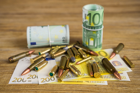 Banknotes and bulletsの写真素材