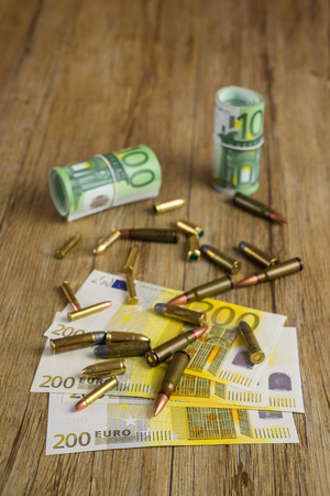 Banknotes and bulletsの写真素材