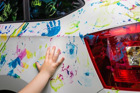 Little girl with colorful car, colorful car decoration, multi-color handprintの写真素材