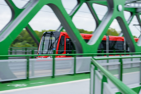 Moving red bus on the new green old bridge in Bratislava