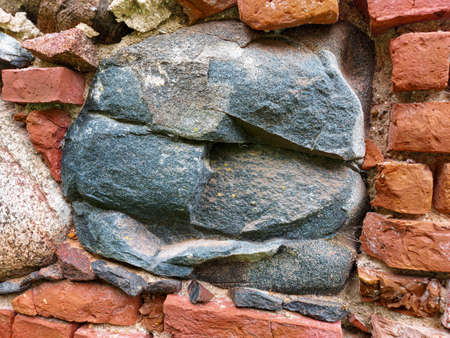 a very old medieval church wall with granite stoneの写真素材