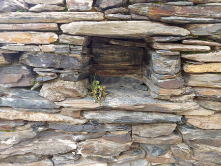 The old bells of Lamaria church next to the huge stone fence Ushguli Georgiaの写真素材