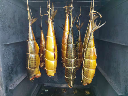 Appetizing smoked fish on kitchen board.Smoked mackerelの写真素材