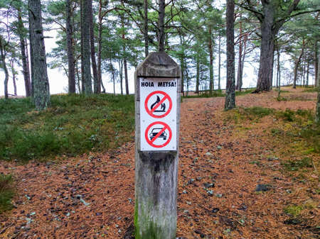 Many prohibition signs on one poster in a summer park. Blank mock-up of an outdoor info banner. Park indications and regulations.の写真素材