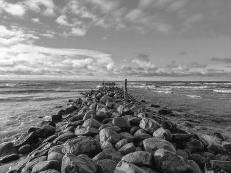 An old stone pier in to the sea on a sunny evening. Dramatic lookの写真素材