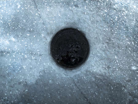 ice hole for winter fishing Lake Peipusの写真素材