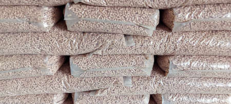 Stack of plastic bags with wood pellets. energy crisisの写真素材