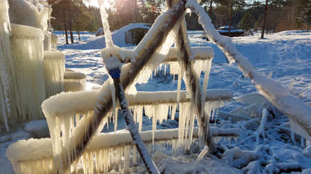 beautiful long icicles frozen water drops on a haystack. Latviaの写真素材