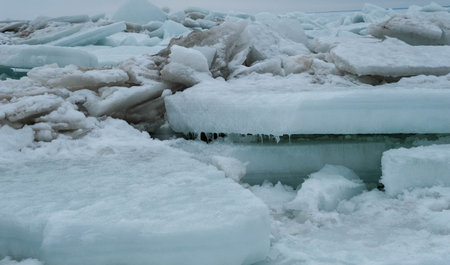 Frozen sea. Huge broken ice blocks stacked up on coast. Stormy weather in Parnu beach