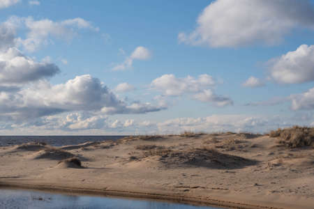 the beach and the blue water of the Baltic Sea and the sky is bluespring. Latvia.の写真素材