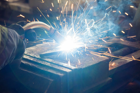 Welding of steel, sparking, not wearing gloves, light colored like fireworks