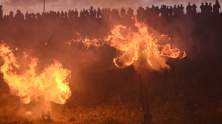 LATVIA, REKU KALNS - JUNE 21, 2022: Ethnographic traditional rituals with burning signs. Latvian Signs of Powerのeditorial素材