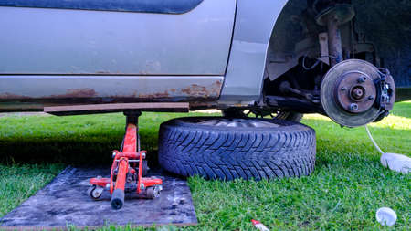 Take off the car wheels by car lift jack.の写真素材