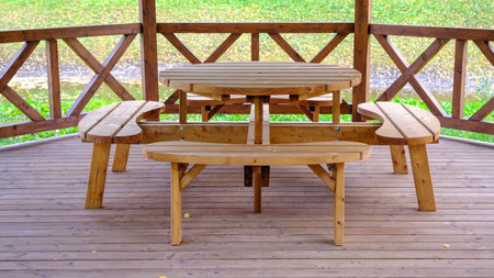 Wooden gazebo interior with benches and tablesの写真素材
